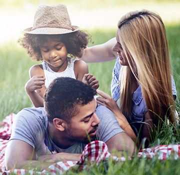 Young family enjoying a picnic in a park.