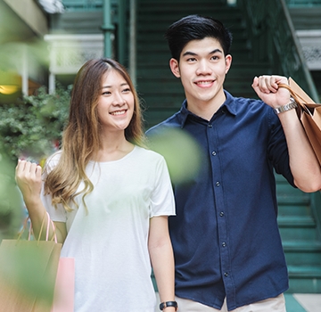 Young couple out shopping in urban mall.