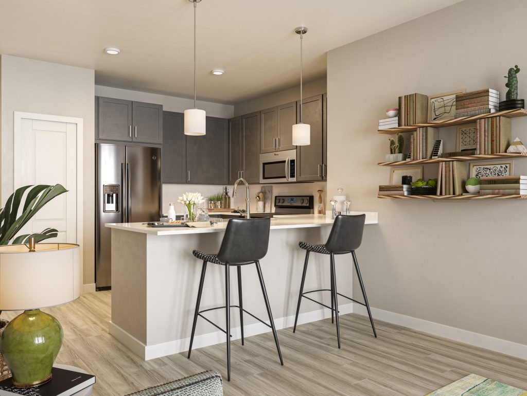 Kitchen with stainless-steel appliances, wood-style flooring, designer lighting and bar seating
