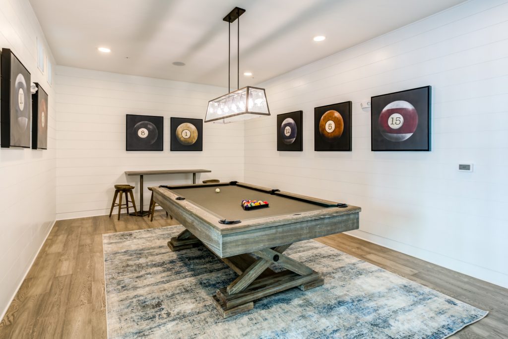 Indoor clubhouse area with pool table and wood-style flooring